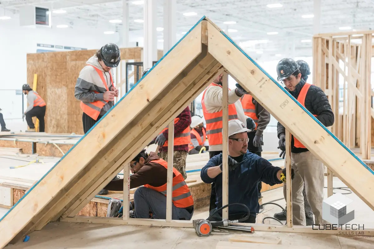 CUBE Tech trainees assembling a prefabricated timber roof frame together — Path 2 Purpose program imagery